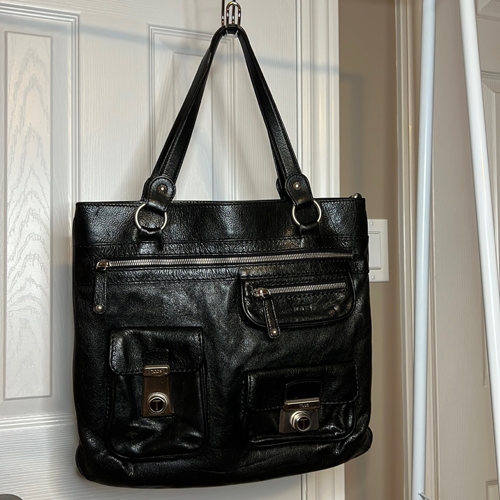 Tod’s black leather tote with multiple front compartments on front and inside